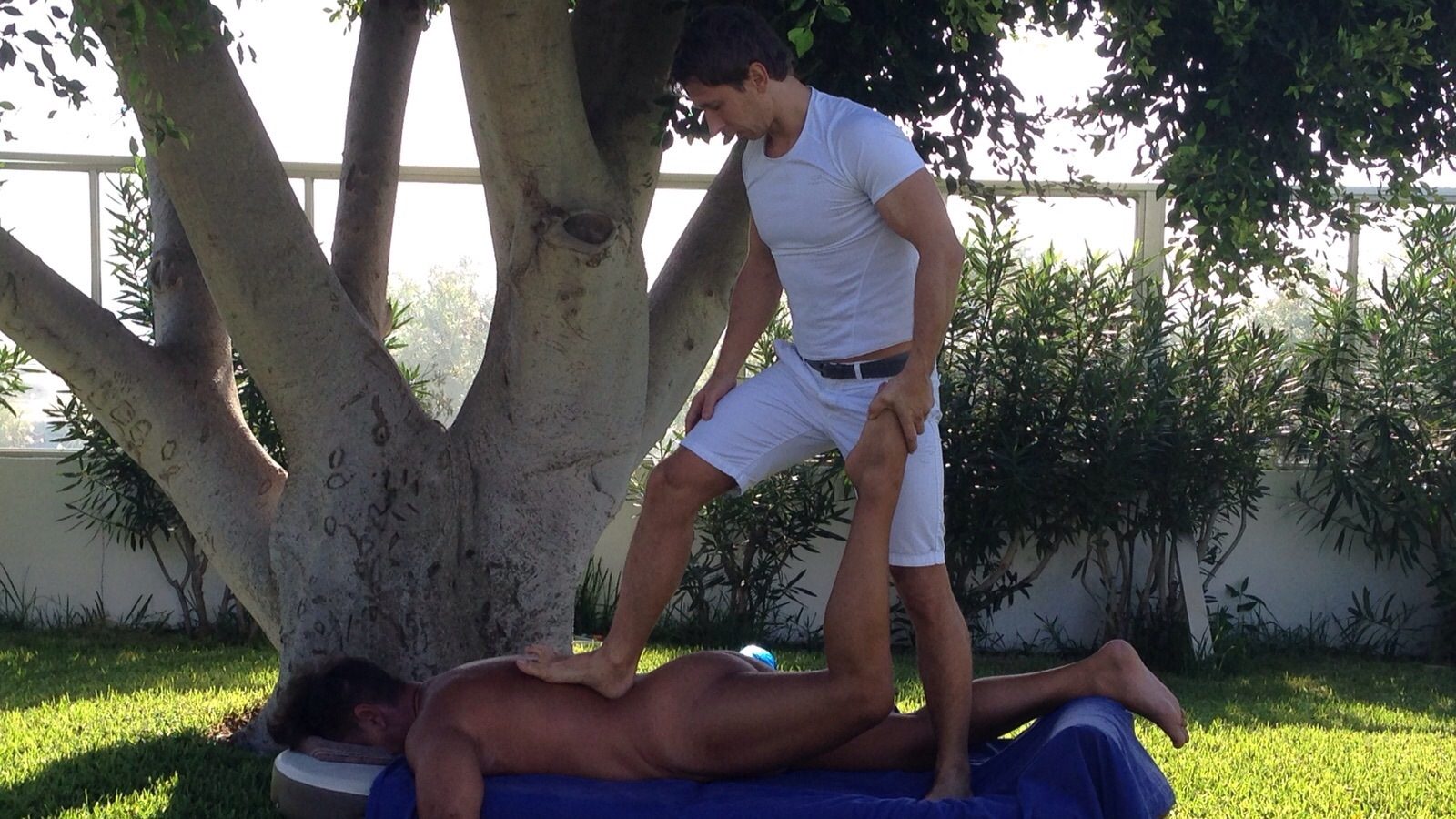 Deep tissue massage under a fig tree in a garden in Maspalomas, Gran Canaria